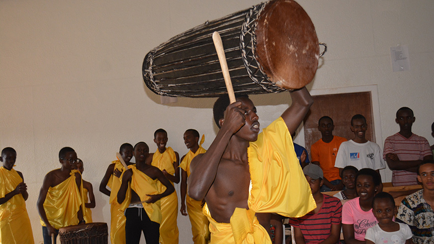 Students showcase Burundian culture to beat traditional drum.
