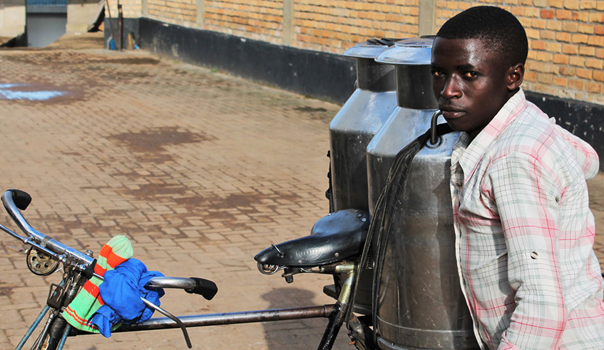 Emmanuel Abayisenga carrying milk on his bicycle. Photo: Stefano Consiglio, IFAD