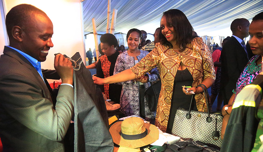 Minister of Trade and Industry, Soraya Hakuzumuremyi (right), inspects some Made-in-Rwanda products at an expo at Kigali Cultural Village on Thursday. Sam Ngendahimana