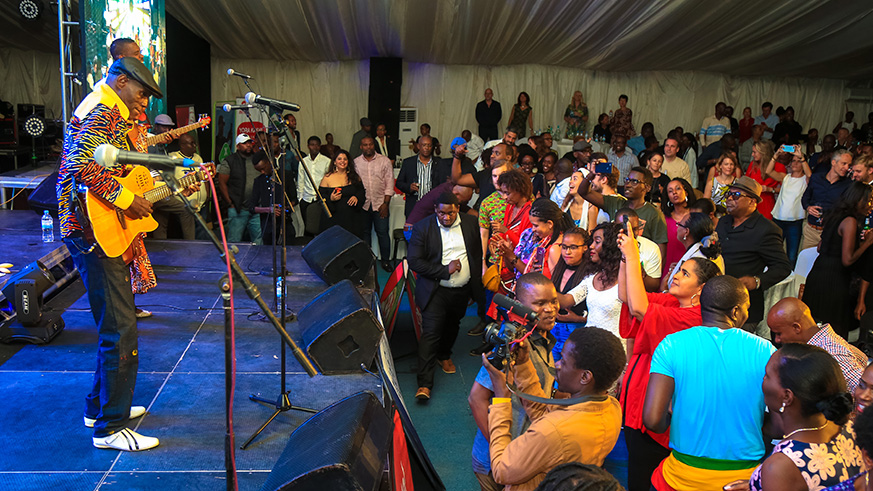 Revelers dance as Zimbabwean Afro Jazz legend Oliver Mtukudzi performs during the Kigali Jazz Junction on Friday at the Kigali Serena Hotel. Faustin Niyigena.