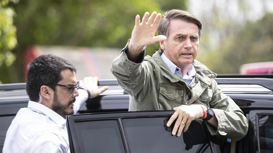 Presidential candidate Jair Bolsonaro waves to his supporters as he leaves a polling station in Rio de Janeiro, Brazil, on Oct. 28, 2018. Right-wing candidate Jair Bolsonaro won Brazil's presidential run-off on Sunday. (Xinhua/Li Ming)