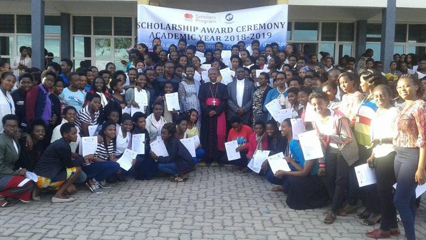 The recipients of the scholarships in a group photo with officials at INES-Ruhengeri. Ru00e9gis Umurengezi.
