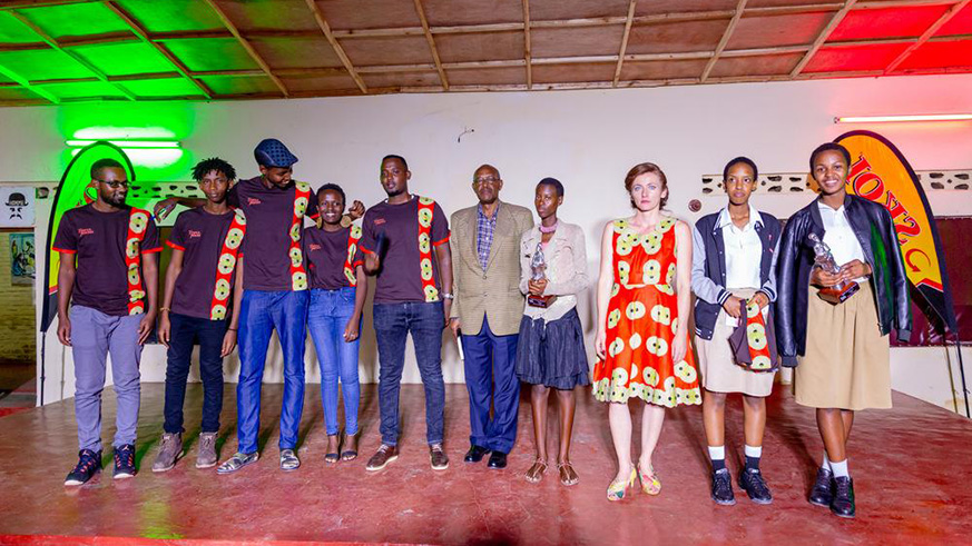 Judges and event organisers in a group photo with the winners of poetry.   Photos by  Charles  Ndushabandi