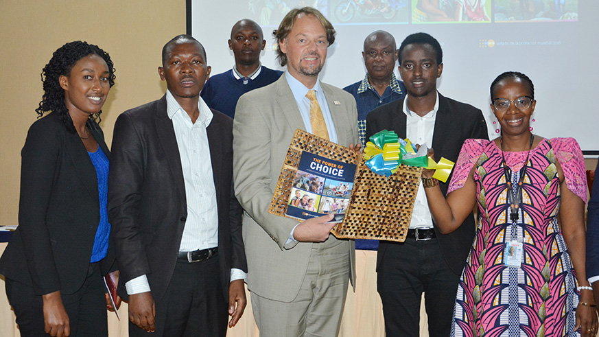 Right to Left, Dr Agnes Ntibanyurwa,UNFPA assistant, Stuart Kyazze  from Minecofin, Mark Bryan Schreiner, the UNFPA Representative to Rwanda,Venant Habarugira,NISR Director of census among other officials.