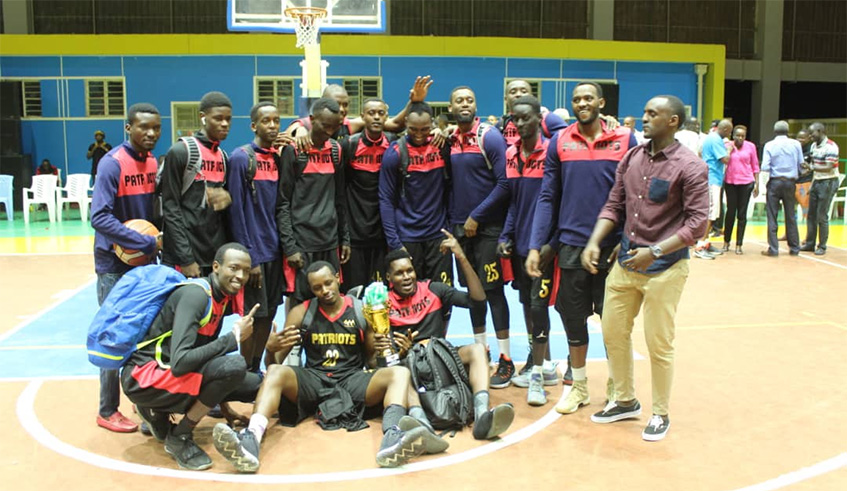 Patriots Basketball Club players celebrate with the trophy after overcoming Espoir 86-84 in the final at Amahoro Stadium on Sunday night. Damas Sikubwabo.