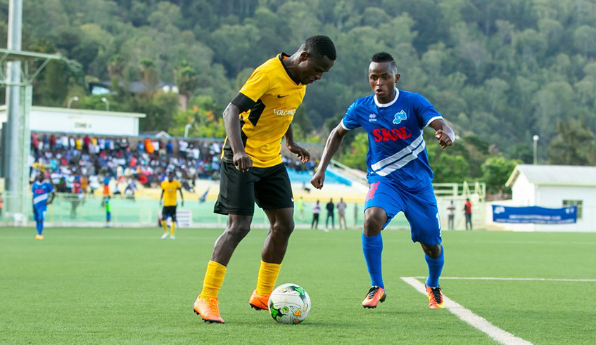 Rayon Sports midfielder Kevin Muhire (right) attempts to get the ball off Mukura VS skipper Hussein Ciza during the 2-1 defeat at Kigali Stadium on Sunday