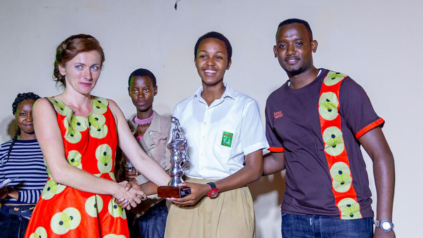 Founders Andrea Grieder and Mustapha Kayitare pose for photo with the overall winner Yassip Casimir Uwihirwe (centre). 