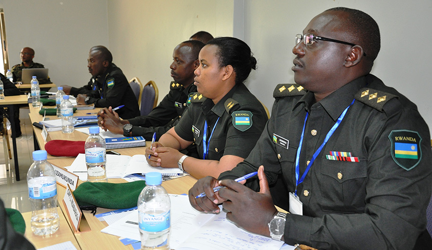 RDF officers follow a presentation during the ongoing training on Prevention of Recruitment and Use of Child Soldiers. Ru00e9gis Umurengezi.