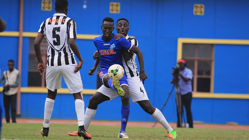 Rayon Sportsu2019 striker Caleb Bimenyimana vies for the ball with APR defender Herve Rugwiro during a past league match at Amahoro Stadium. File photo.