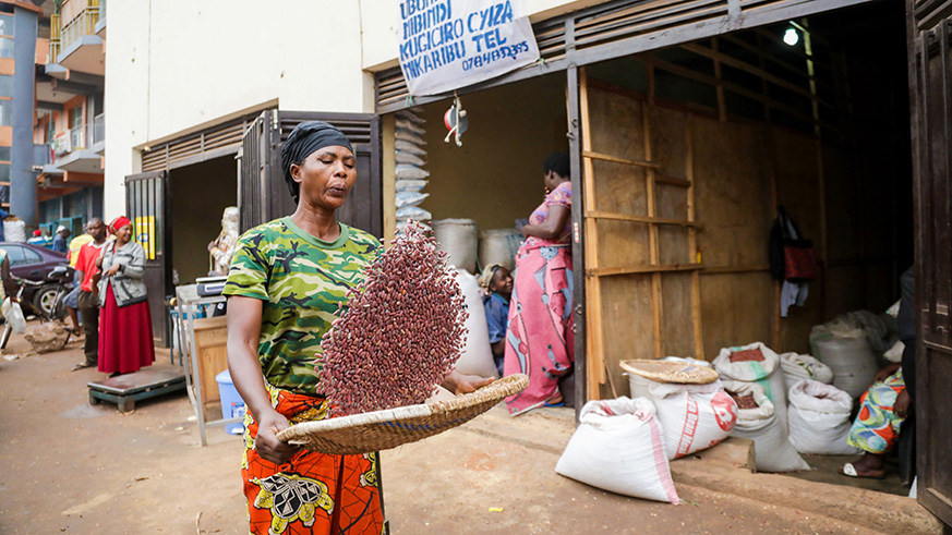 A woman sieves beans before selling them in a shop in Nyabugogo. Beans are one of the staple foods in Rwanda. Emmanuel Kwizera.
