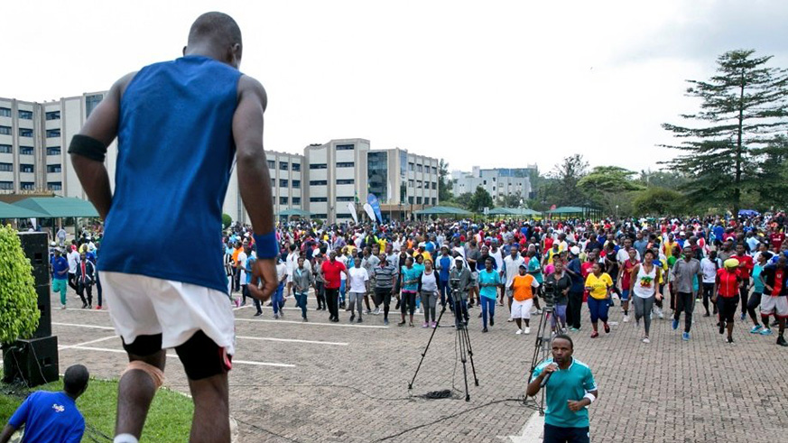 City dwellers engage in physical exercise in the parking lot of Rwanda Revenue Authority in Kimihurura yesterday during the Car Free Day. More and more are embracing the activity that takes place twice every month. Courtesy.