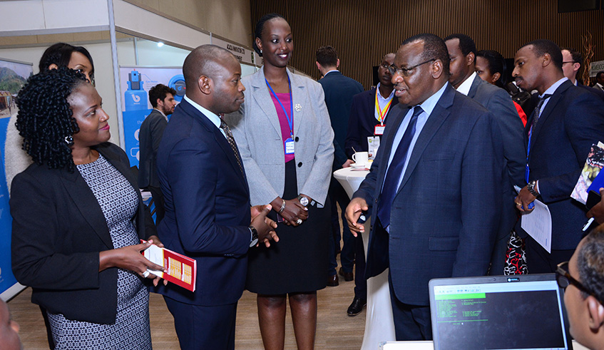 Infrastructure Minister Claver Gatete (in glasses) shares a light moment with some of the delegates attending the Renewable Energy Sustainable Growth Forum that started in Kigali on Monday. At the forum, delegates are exploring ways of reducing dependency on biomass energy, which accounts for over four million deaths across the world annually. Emmanuel Kwizera. 