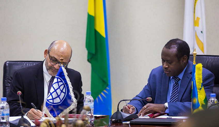 Yasser El- Gammal, the World Bank Group Country Manager, and Finance Minister Uzziel Ndagijimana sign a $20 million credit from the World Bank in Kigali, yesterday.Nadege Imbabazi. 