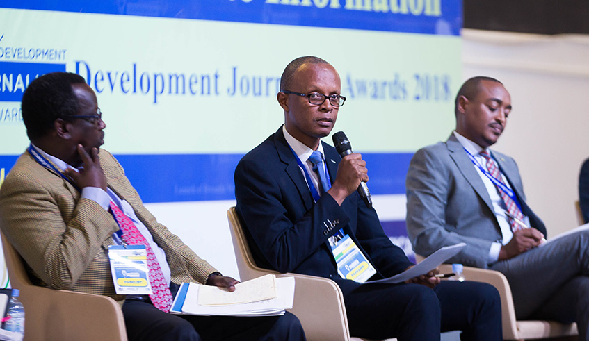 Media High Council Executive Secretary Peacemaker Mbungiramihigo speaks on a panel discussion as University of Rwanda professor Eugene Ndabaga and Swedish Embassyu2019s Clement Kirenga look on at the 10th Africa Information Day celebrations in Kigali yesterday. Nadege Imbabazi.