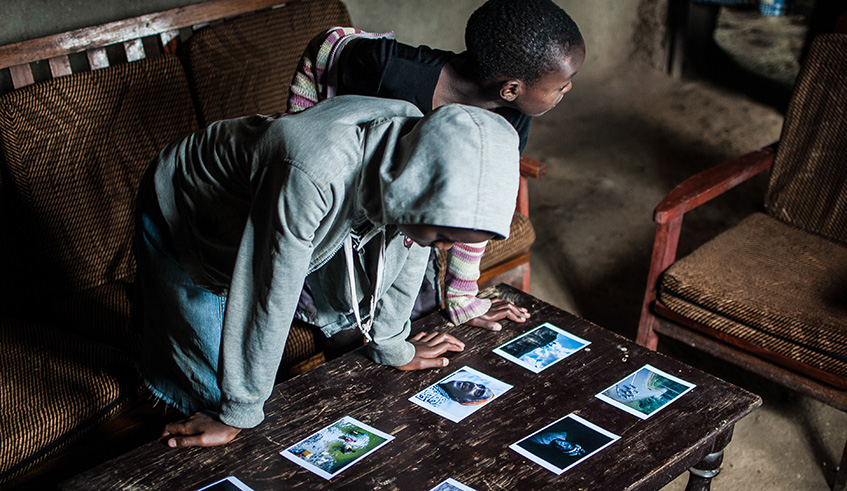 One of the participants in the Home Stay exhibition programme shows off his works to members of the community in Nyabihu District. 