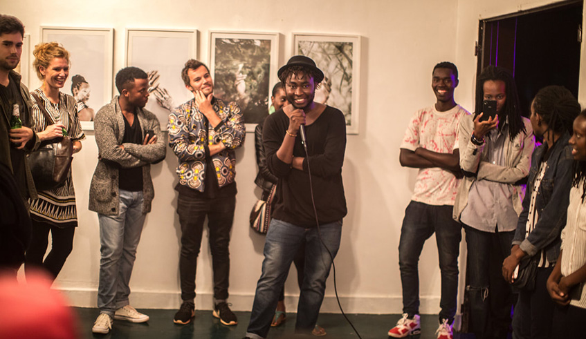 Jacques Nkinzingabo (with a mic), founder of the Kigali Centre for Photography and curator of the upcoming exhibition, speaks at a past exhibition in Kigali. 