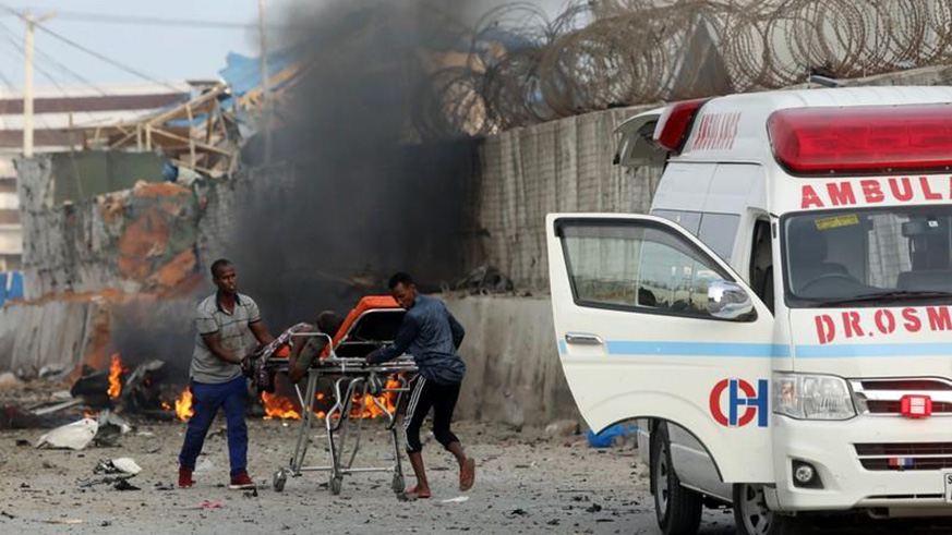 Rescue workers carry an unidentified man injured from the scene of an explosion in Mogadishu, on Friday. Net photo.