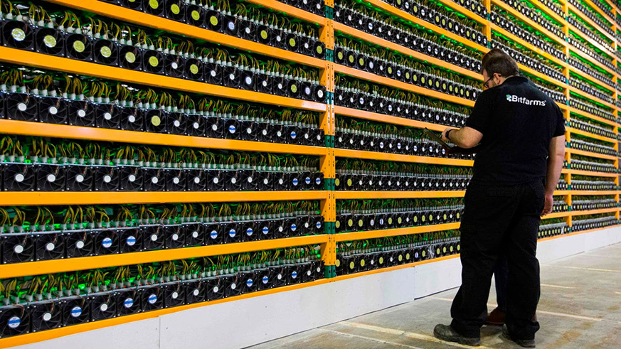 Technicians inspect a bitcoin-mining operation at Bitfarms in Saint-Hyacinthe, Quebec. Net photo.