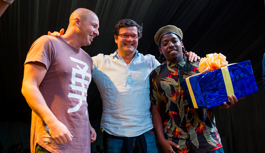 DJ Kiss (R) poses with his prize as the winner of the Battle of the DJs in a photo, alongside EU Ambassador to Rwanda Nicola Bellomo (C), and DJ Shine from France. Courtesy photos. 