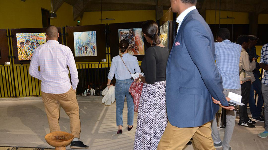 People check out works at u2018The Journey With The Sunu2019 exhibition, which is on display at the School of Architecture and Built Environment, in Kigali.
