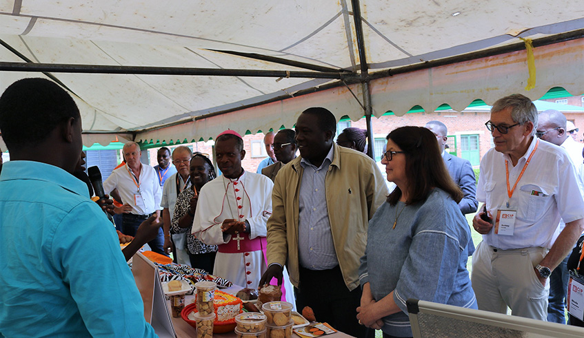 Guests interact with some of the entrepreneurs making different products using orange fleshed sweet potatoes.