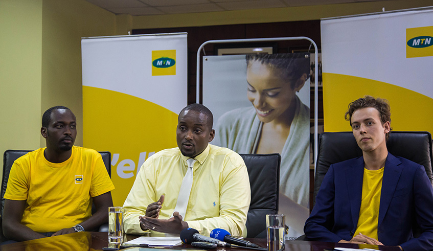 The Senior Manager Operations at MTN Rwanda Desire Rudahunga (C) explains about New MyMTNapp during the news conference as product developers Rene Nzabakira (L) and Sebastian Vonen look on. Nadege Imbabazi