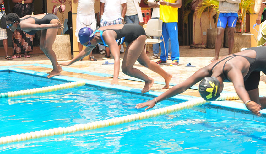 Riviera High School swimmers take a dive into the pool during the 4th edition of the annual inter-school competition at Hilltop Hotel last year. File photo.