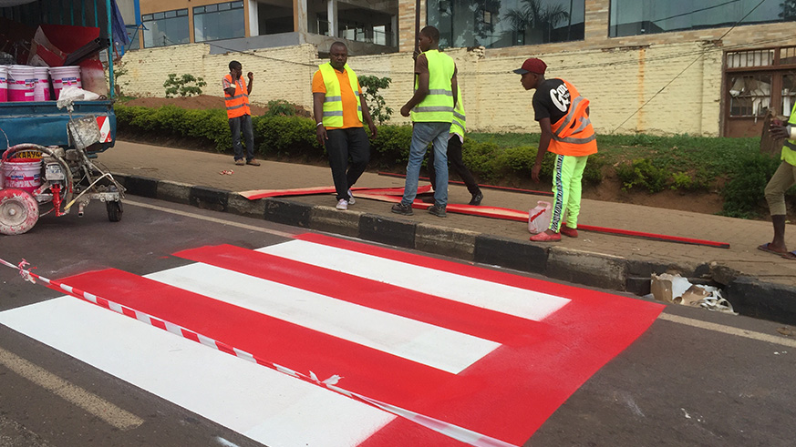 New Zebra crossing marks being established along airport road in Kigali. Government is set to table a new law before parliament which will ensure motorists respect more such traffic signs among other road rules. Athan Tashobya.