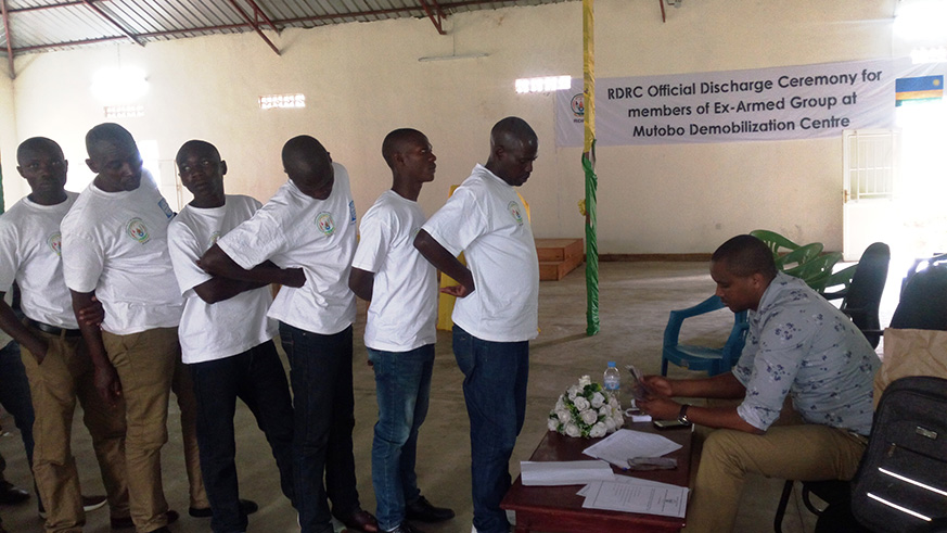 Some of discharged ex- combatants queue to receive Rwf 60,000 per each, the money which is considered as the starting capital. Regis Umurengezi