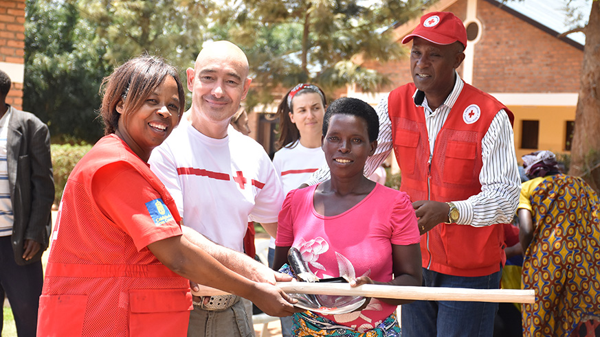 Speciose Nyiranteziryayo (R) receives some donations from a Red Cross volunteer. / Courtesy