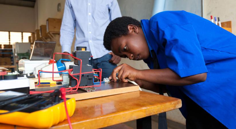  A vocational student from Groupe Scolaire ADB Nyarutarama High School in Gasabo District, fixes her project of design and implementation of sound signaling system. (File)