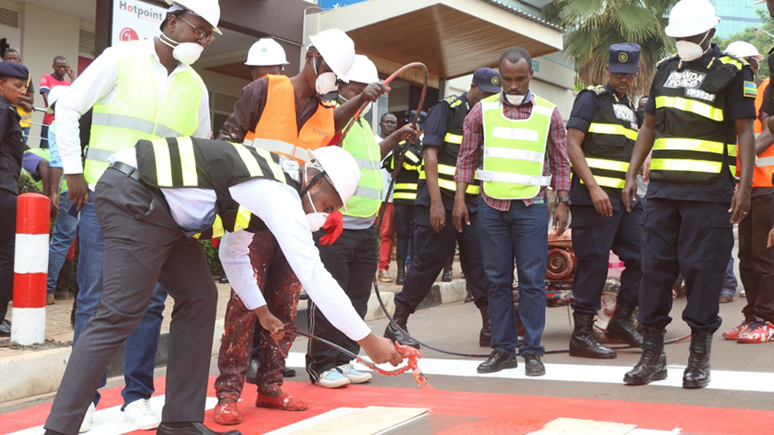 State Minister for Transport, Eng. Jean de Dieu Uwihanganye, paints a crosswalk to kick-start the countrywide exercise yesterday. Courtesy.