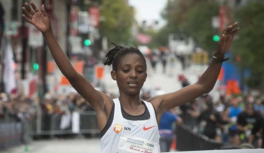 Salome Nyirarukundo raises her arms in victory, as she crosses the finish line at the 2018 Montreal Marathon on September 23. Net photo.