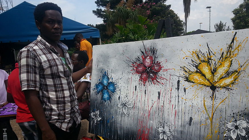 Girbert Ngendahayo shows off one of his creations.  