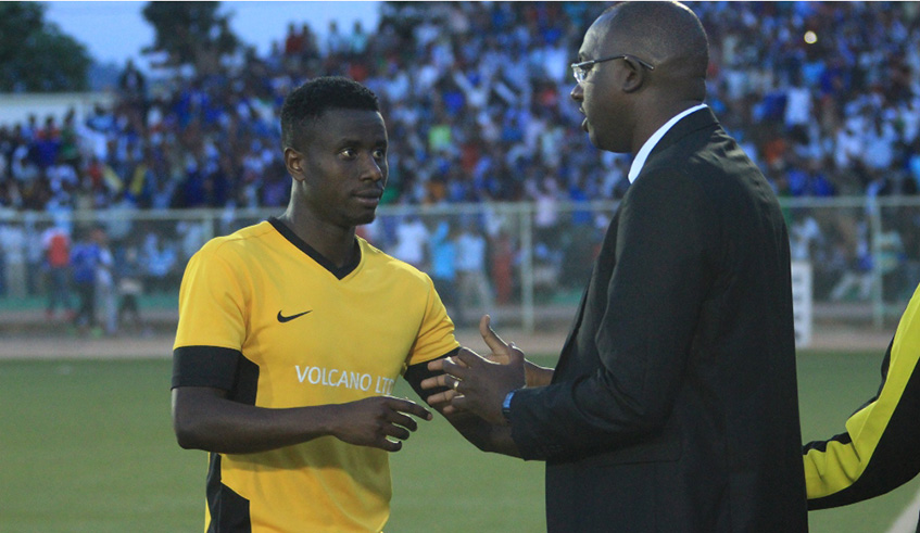 Mukura VS coach Francis Haringingo briefs defender Hassan Rugirayabo during a past Peace Cup game at Kigali Stadium. File photo.