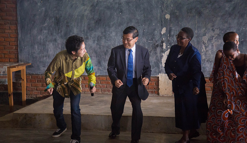 Japanese ambassador to Rwanda Takayuki Miyashata (centre), and the headmistress of Umuco Mwiza School,  Francoise Tuyikunde take part in the dance workshop by Nakagome (left).