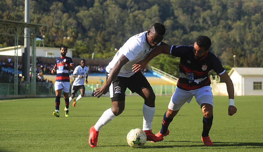 APR FC midfielder Muhadjili Hakizimana vies for the ball with Club Africainu2019 s left back Ali Abdi during the first leg match at Kigali Stadium on Wednesday. Sam Ngendahimana.