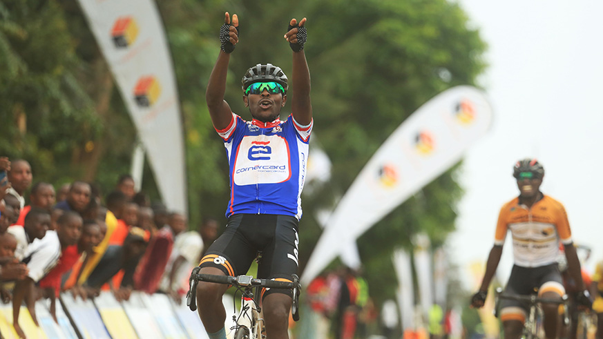 Gasore Hategeka throws his arms in the air as he celebrates his Race for Culture victory in Rwamagana District on Saturday. Sam Ngendahimana.