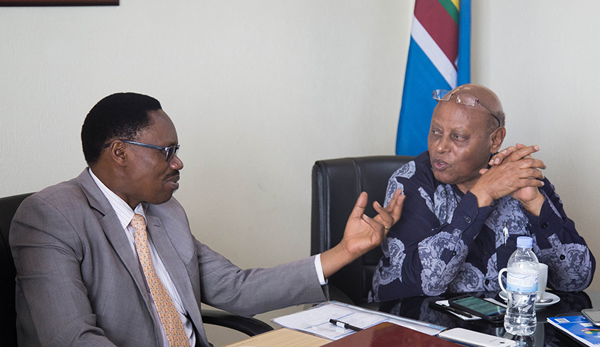 Cyprien Niyomugabo (left) chats with James Vuningoma, RALC Executive Secretary, during a meeting aimed at formulating a strategy on how to adopt and implement Kiswahili in different levels of governance. 