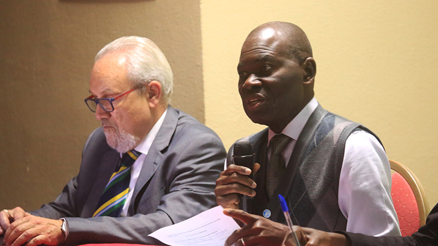 FAO Country Director Gualber Gbehounou addresses the meeting as Cesar Alvarez, Senior Information Technology Officer at FAO looks on in Kigali on Wednesday . Sam Ngendahimana