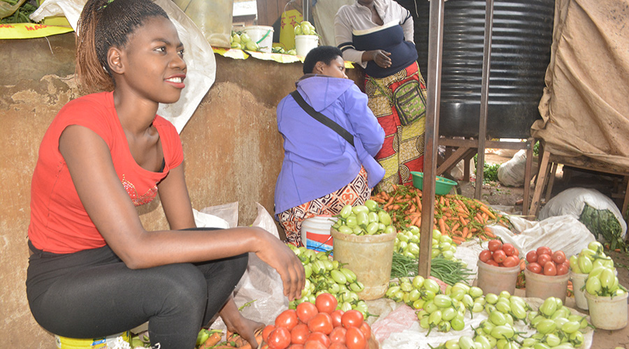 Gisele Ingabire in her stand where she sells vegetables in Kabuga. / Jean d'Amour Mbonyinshuti