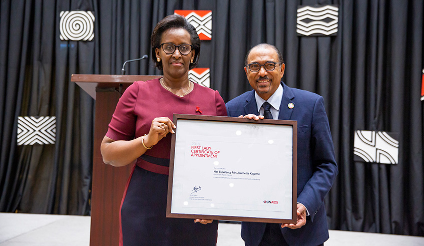 First Lady Mrs Jeannette Kagame receives her recognition as Special Ambassador for Adolescent Health and Well-being from Michel Sidibe, UNAIDS Executive Director, at Kigali Convention Centre yesterday. Courtesy.