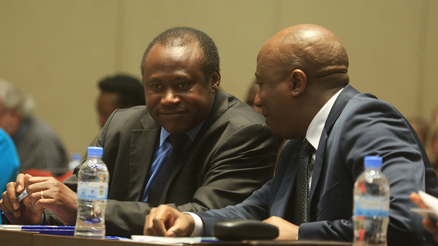 Edouard Ngirente consults with  Minister Uzziel Ndagijimana during  the official launch of the report (Sam Ngendahimana)