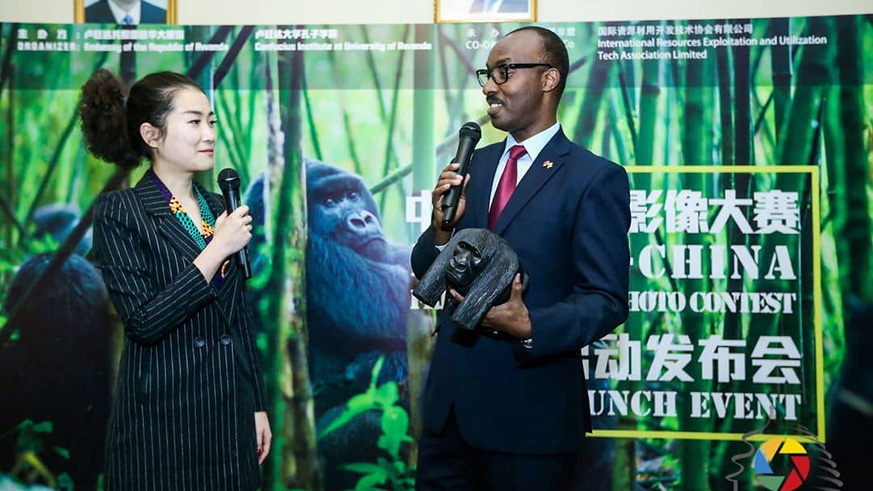 Rwandau2019s Ambassador to China Charles Kayonga (right) gives a dummy gorilla to one of the partnering organisers at the event. Courtesy.