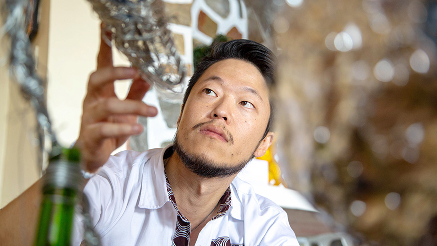 Peter Lee examines a sculpture in the gallery. Ann Singer