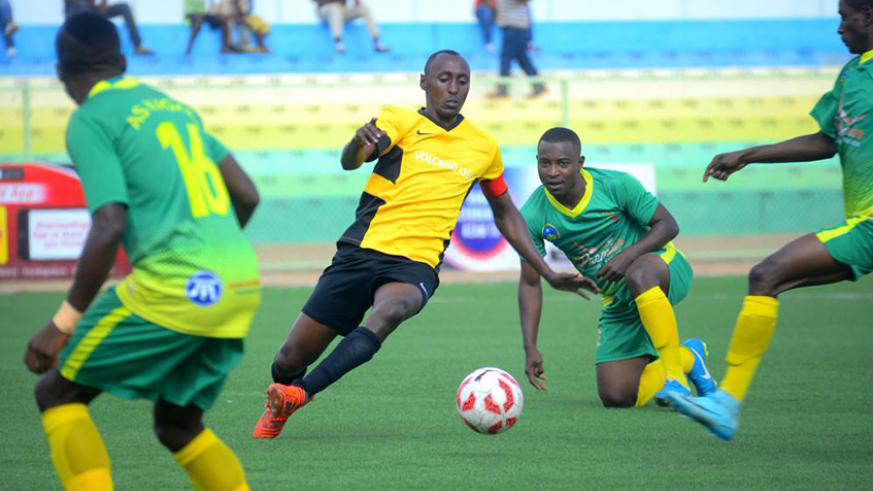Burundian Christophe Ndayishimiye (centre) scored the lone goal in the 10th minute to inspire Mukura to the top. He is seen here battling for the ball against AS Kigali players in a past league match at Huye Stadium. File photo.