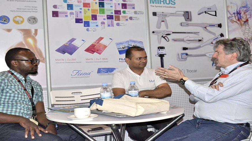 Sandeep Pandya (C), in a discussion with customers during the exhibition at Kigali Convetion Centre.