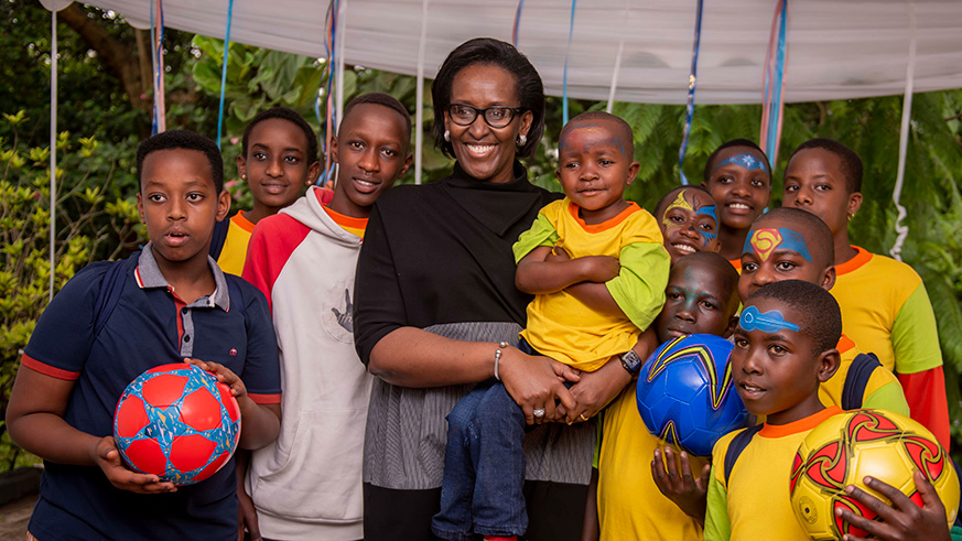 First Lady Jeannette Kagame posing for pictures with some of the children at the end of year party. Village Urugwiro.