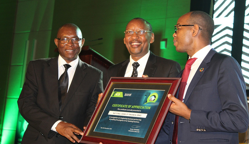 Central Bank Governor John Rwangombwa receives a certification from KCB Rwanda MD George Odhiambo (LEFT) and KCB Group CEO Joshuo Oigara (Right). Photo by Eddie Nsabimana.