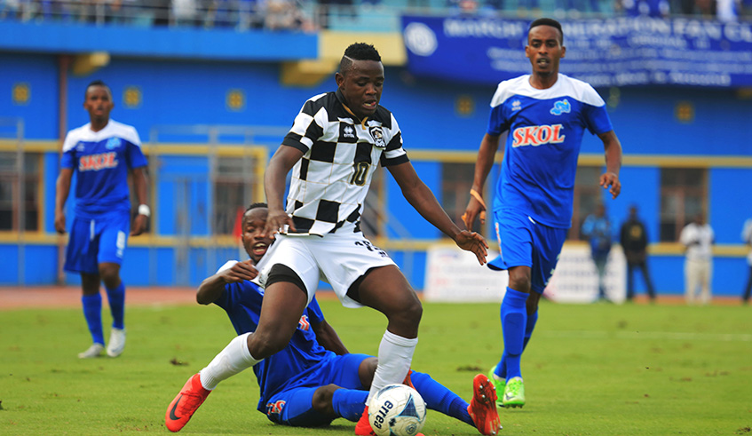 APR forward Muhadjiri Hakizimana rounds off Rayon Sports skipper Thierry Manzi in a two-man duel as Eric Rutanga (R) and Kevin Muhire (L) look on during a past league match at Amahoro Stadium. Sam Ngendahimana.
